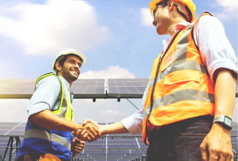 two workers shaking hands